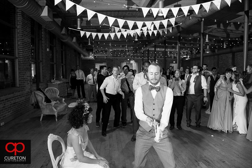 Groom tosses the garter.