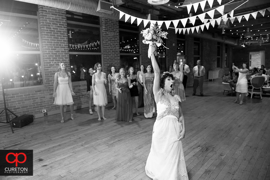 Bride tossing her bouquet .