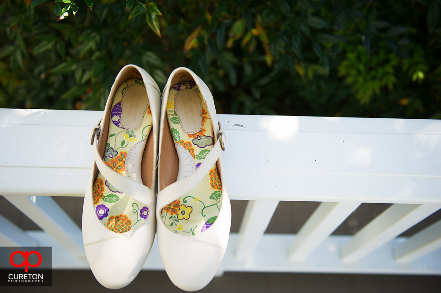 Bride's shoes on a railing.