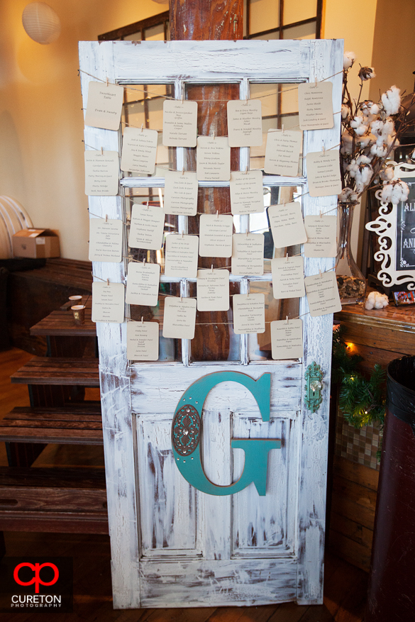 Old door used at wedding as seating map.