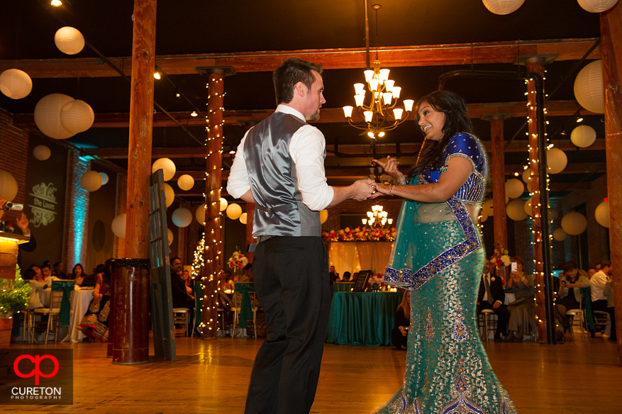 Couple dancing their first dance at their wedding reception.