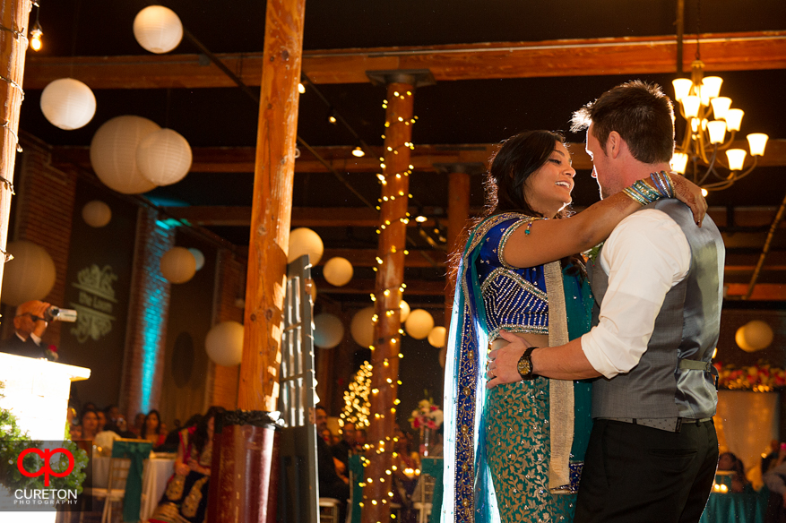 Bride looks at Groom during a dance at their Indian wedding reception.