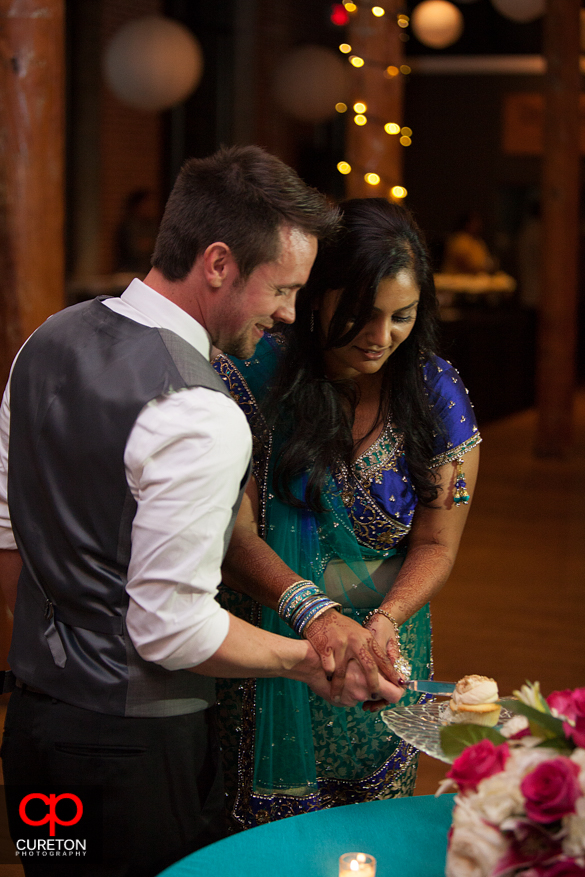 Bride and Groom cutting their cake.