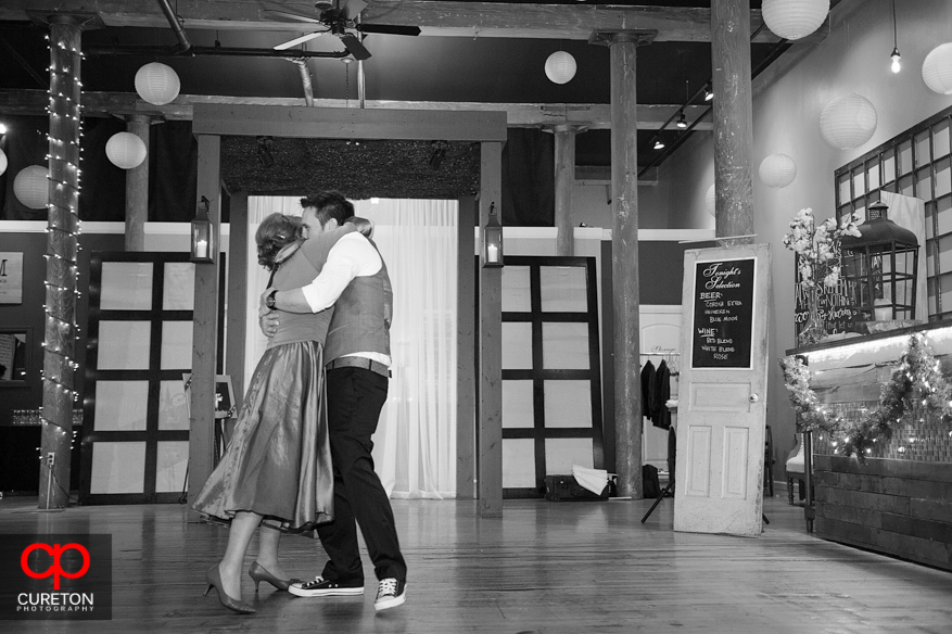 Groom and mom hugging after their dance.