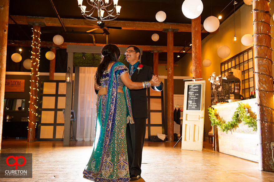 Bride and father dance at her Indian wedding reception.