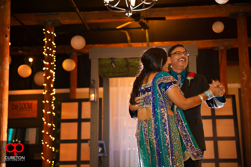 Dad laughing during father-daughter dance at the reception.