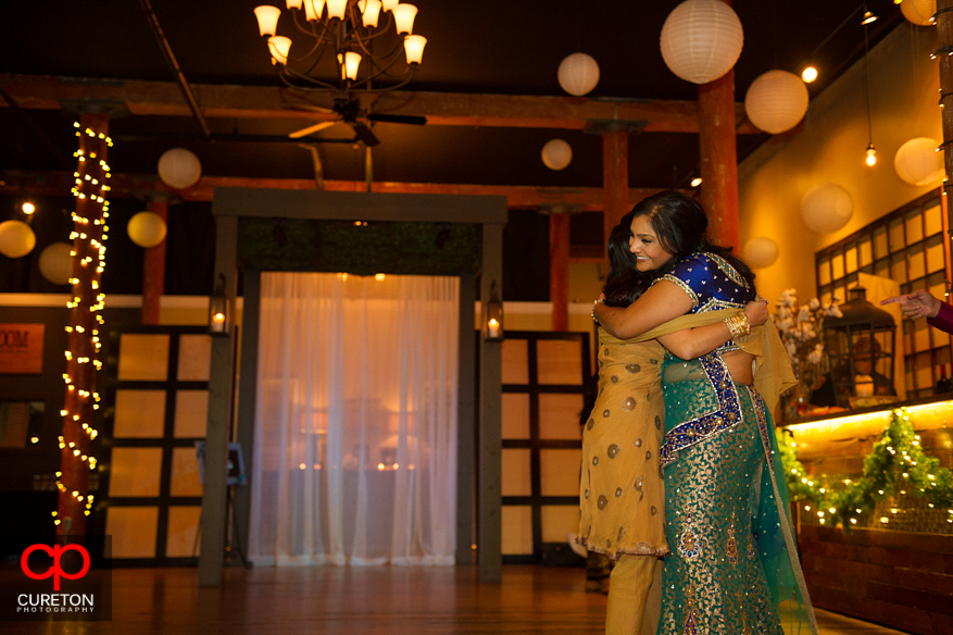 Bride hugging her family after the toast.