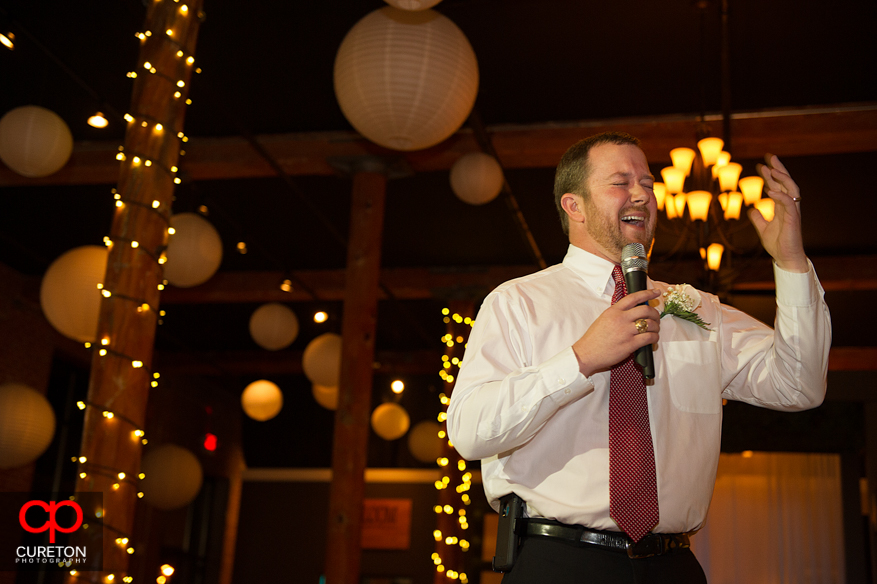 Groom's friend gives a toast.