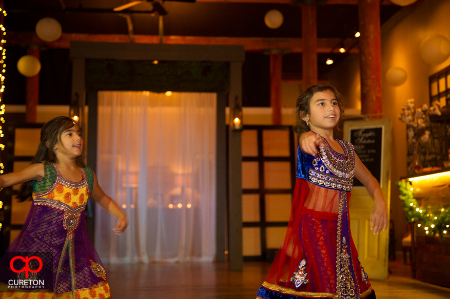 Flower girl dancing a traditional Indian dance at the reception.