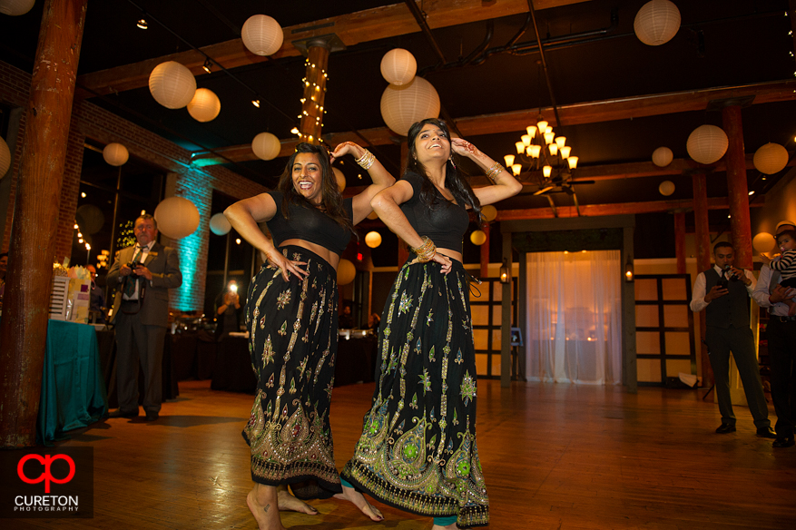 Bride's sister performs for her at her Indian wedding reception.