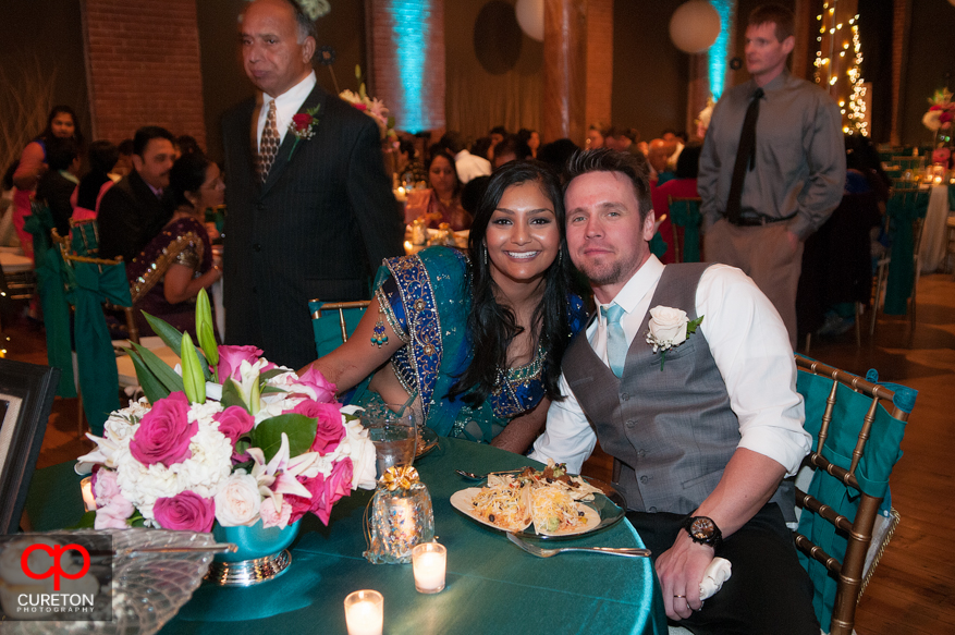 Bride and groom at their table during the reception.