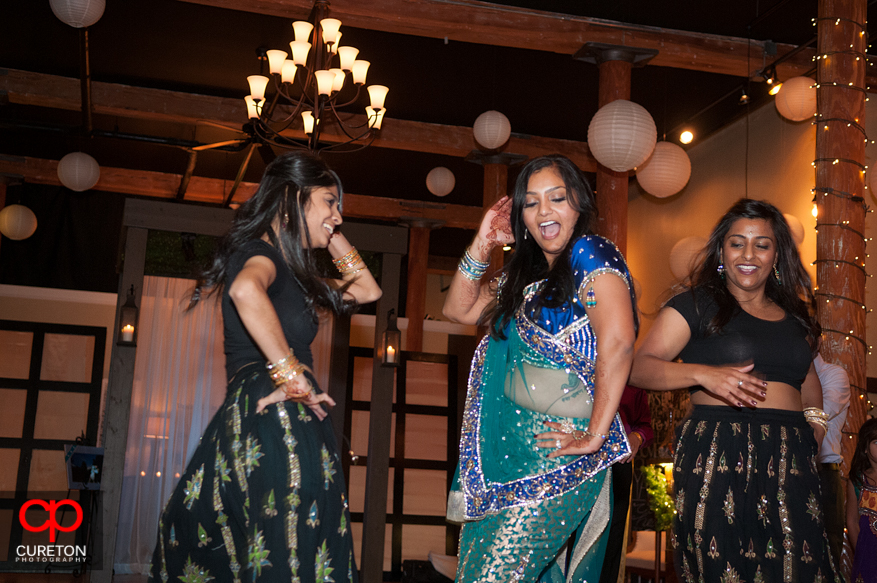 Bride dances with her sister after her performance at the reception.