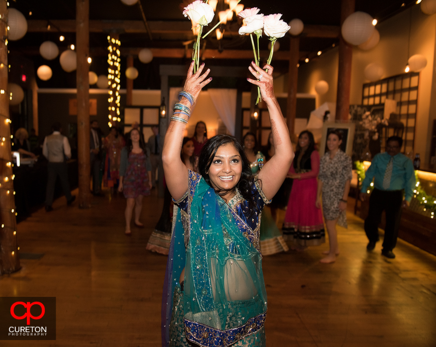 Bride throwing flowers instead of bouquet .