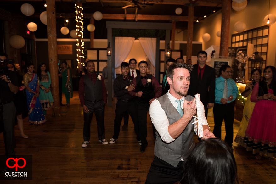 Groom prepares to throw garter.