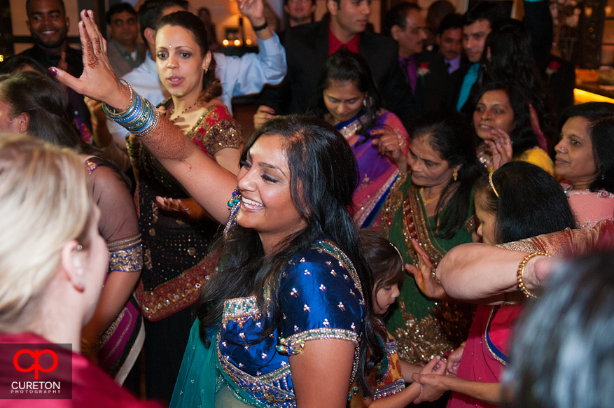 Bride dancing with friends at her wedding reception.
