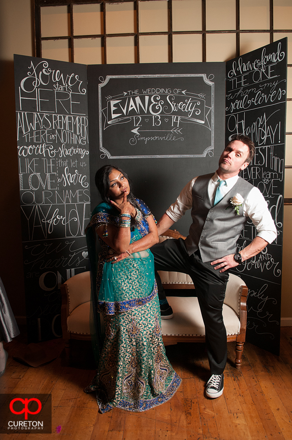 The newlyweds posing in the photo booth.