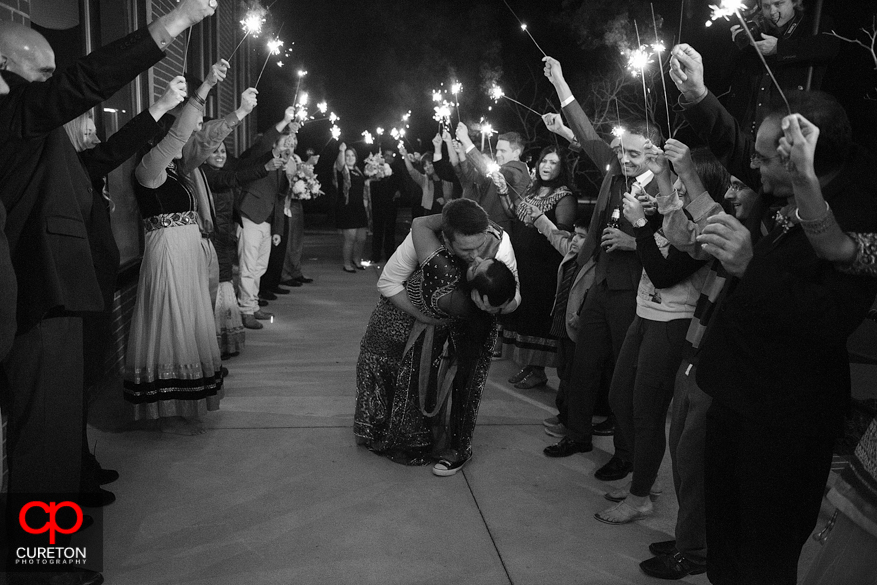 Groom dipping the bride during a sparkler leave.