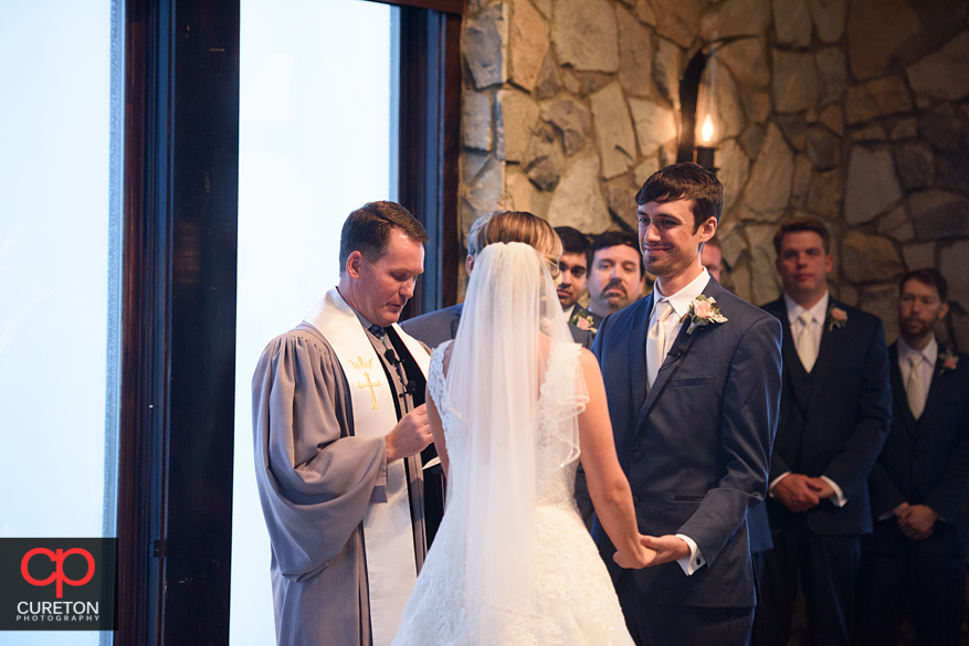 Groom looks at his bride during their Glassy Chapel wedding.