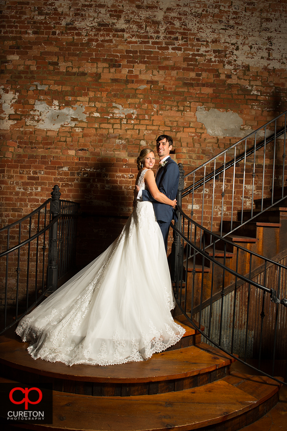 Bride and Groom on the staircase at the Old Cigar Warehouse.