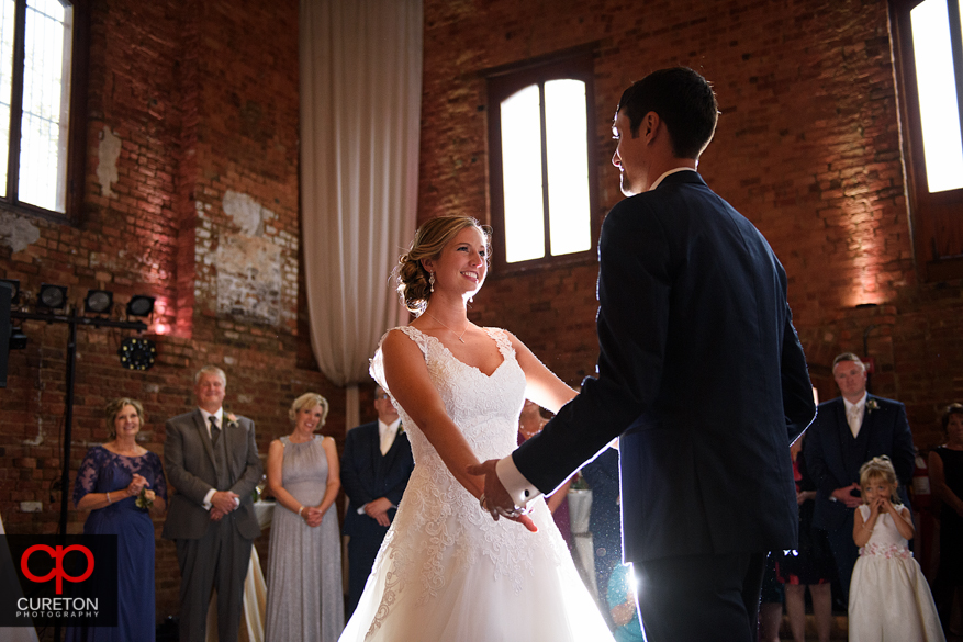 Bride and groom have a first dance at the Old Cigar Warehouse.