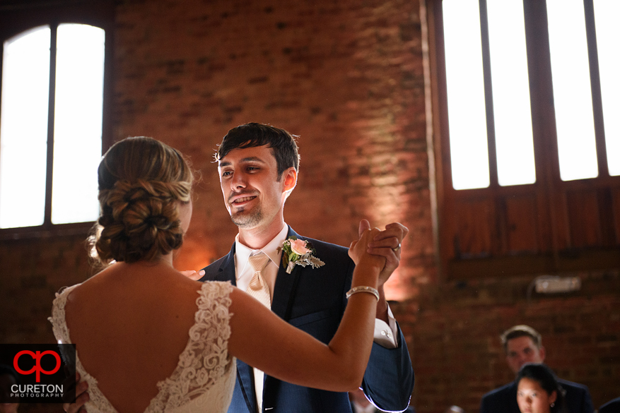 Bride and groom have a first dance at the Old Cigar Warehouse.