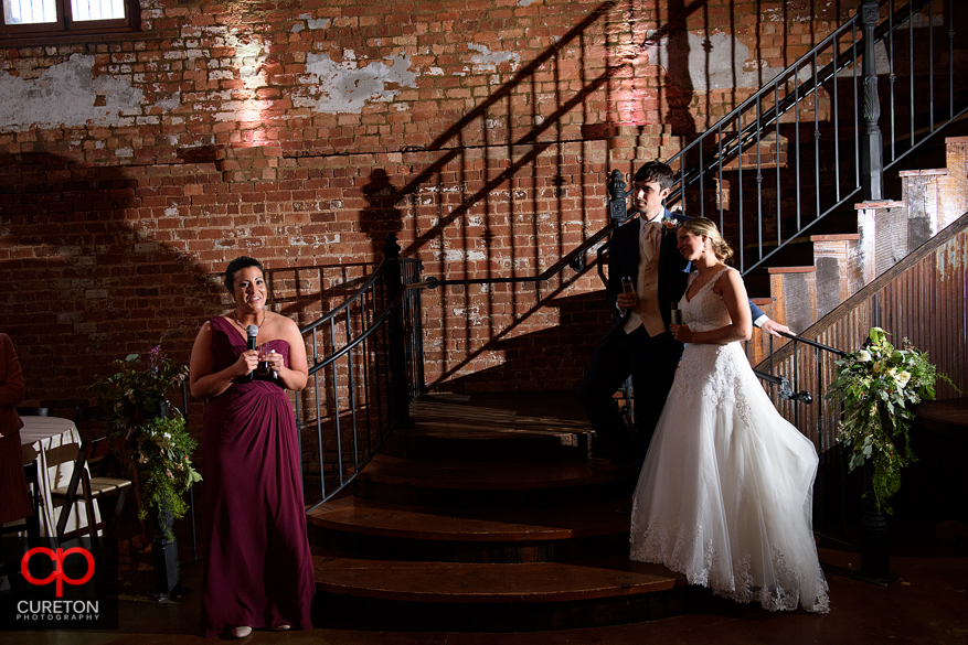 Bride and groom listed to toasts at the reception.