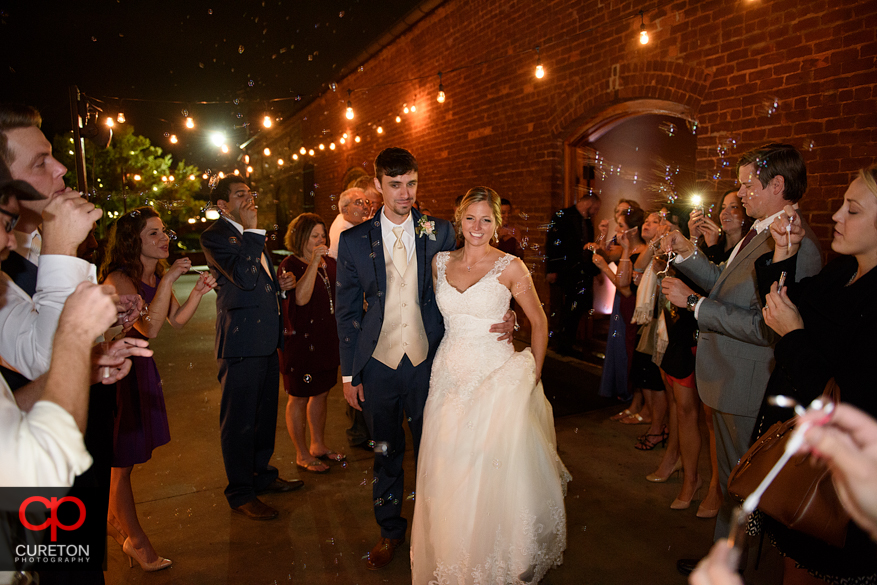 Wedding leave through bubbles at the Old Cigar Warehouse.