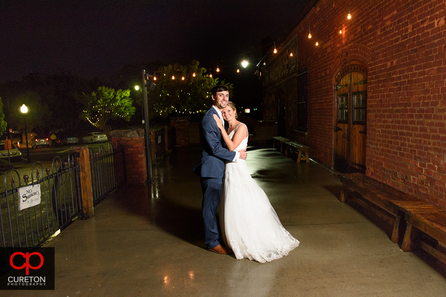 Couple standing in front of the Old Cigar Warehouse in downtown Greenville,SC.