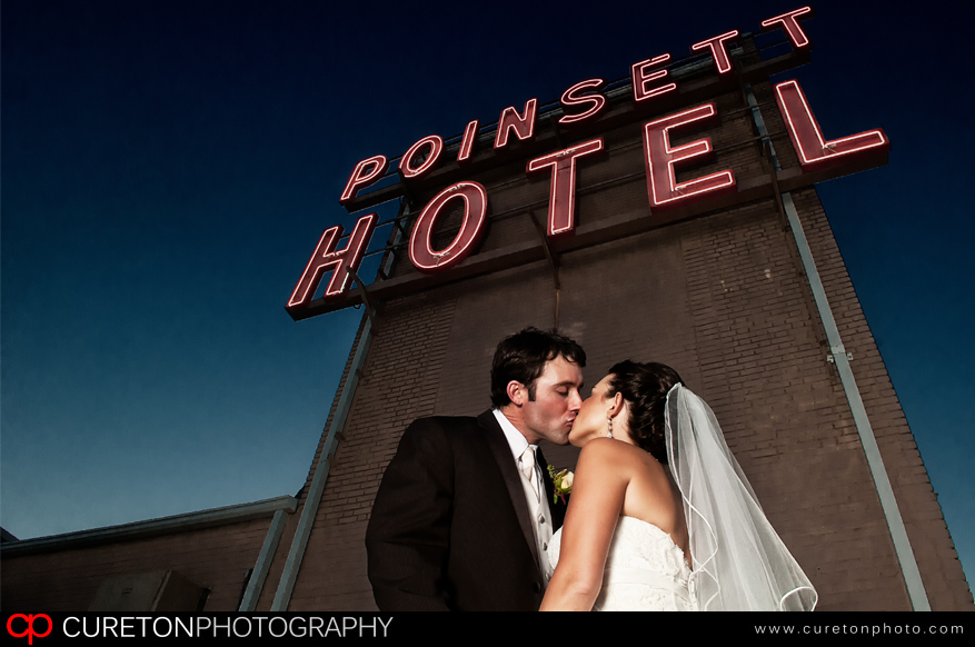 A couple kissing after thier wedding on the roof of the Westin Poinsett in Greenville,SC.
