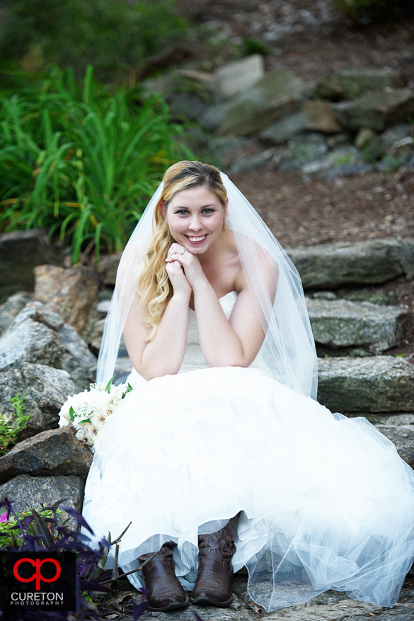 Bride on the steps of the rock quarry garden.