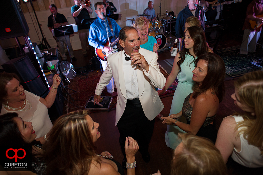 Groom dancing with guests at the wedding.