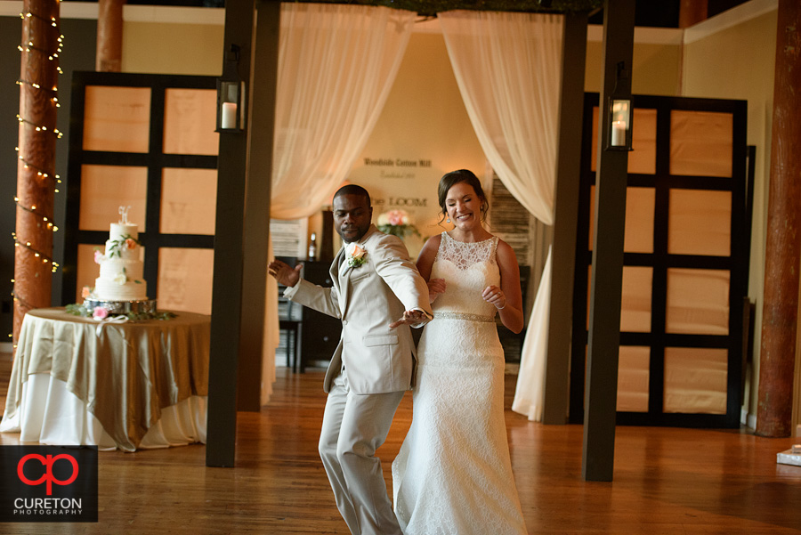 Bride and groom dancing into the reception.