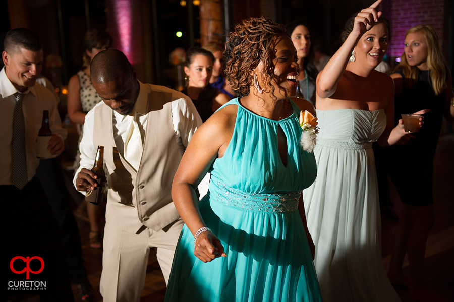 Guests dancing at the wedding reception at The Loom in Simpsonville,SC.