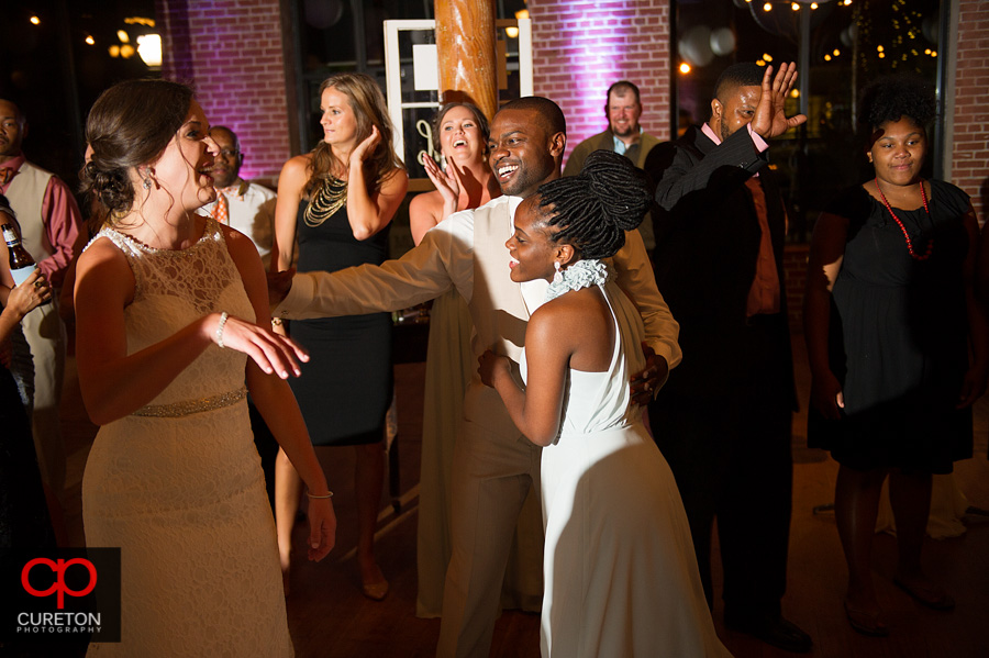 Guests dancing at the wedding reception at The Loom in Simpsonville,SC.