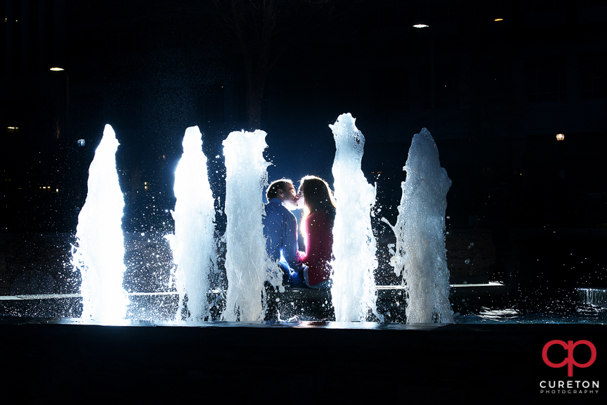Epic pre-wedding fountain photo during an engagement session in downtown Greenville,SC.