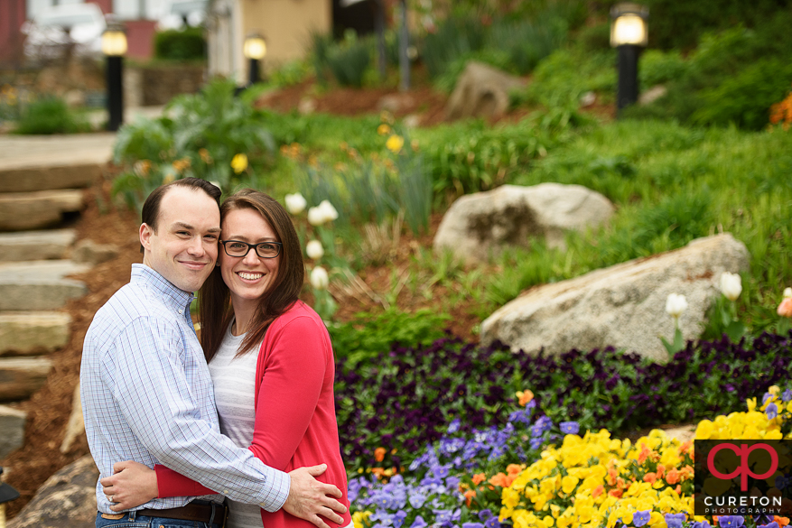 Engaged couple cuddling in downtown Greenville,SC.