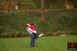 Man lifting his fiancee during a sessionin downtown Greenville,SC.