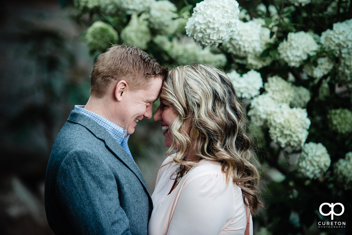 Engaged couple touching foreheads during their Rock Quarry Garden Engagement Session.
