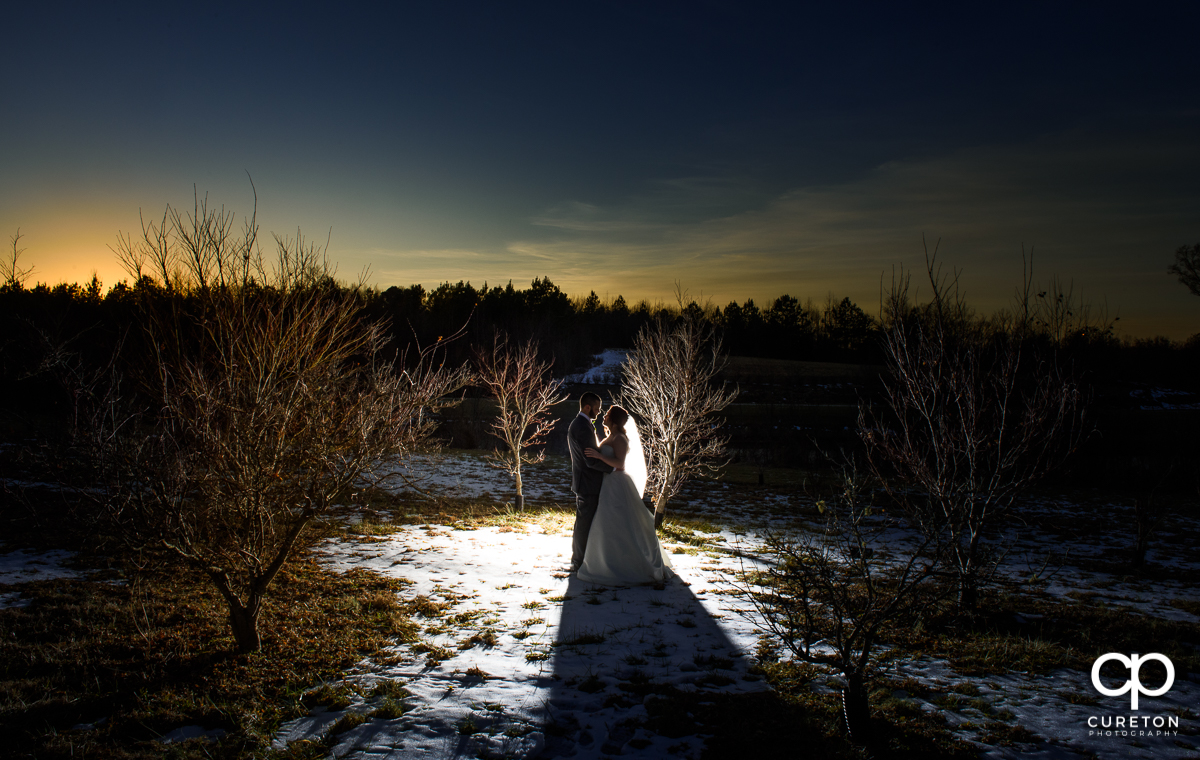 Bride and groom in the snow after their wedding ceremony at The Arbors in Cleveland,NC.