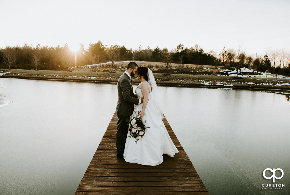 Bride and groom on a pier during their wedding near Lake Norman North Carolina.