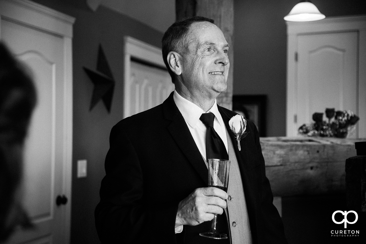 Bride's father looking at his daughter in her dress for the first time.