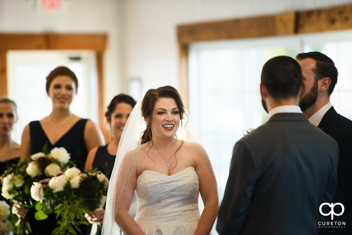 Bride smiling during the ceremony.
