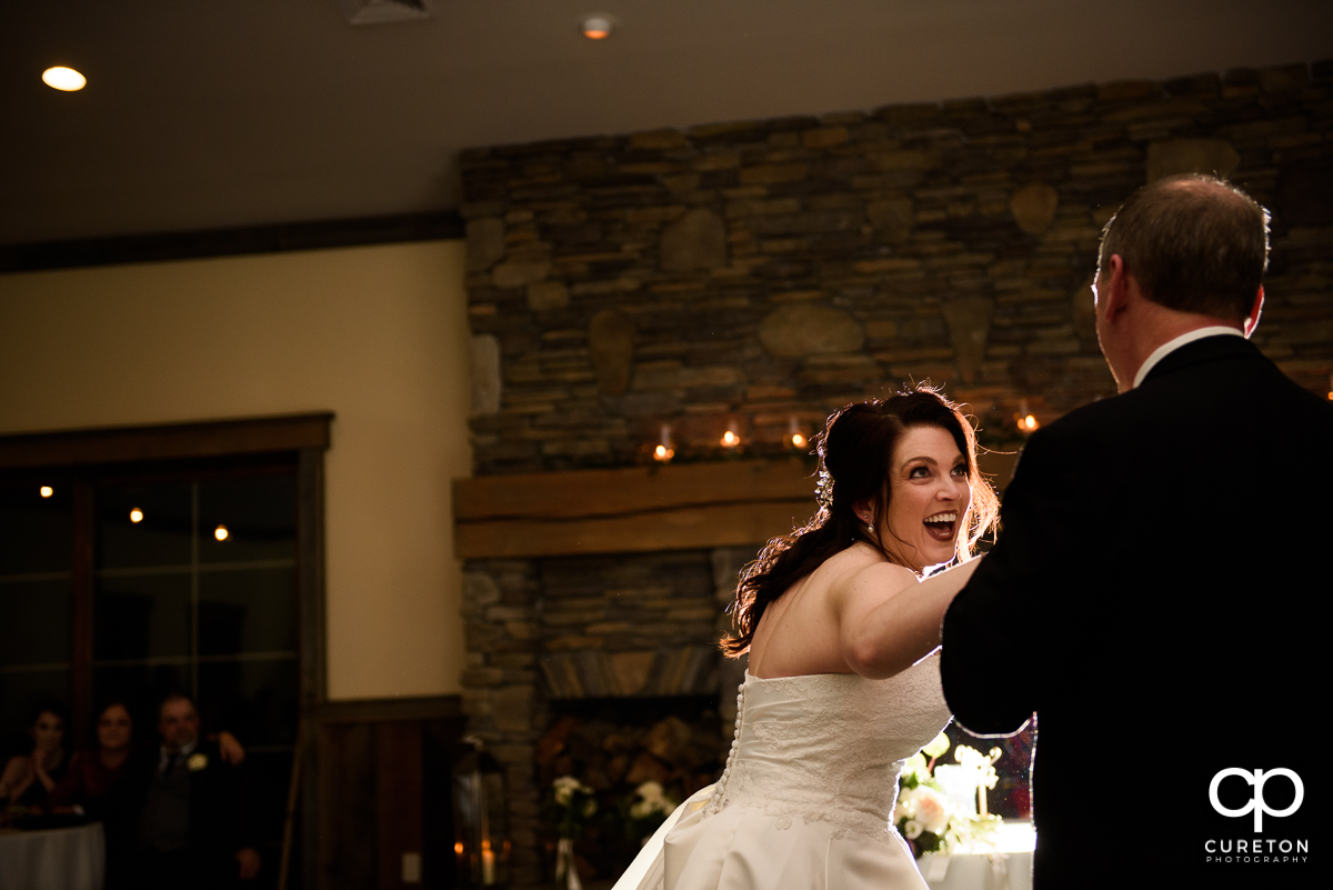 Bride smiling during the dance with her father.