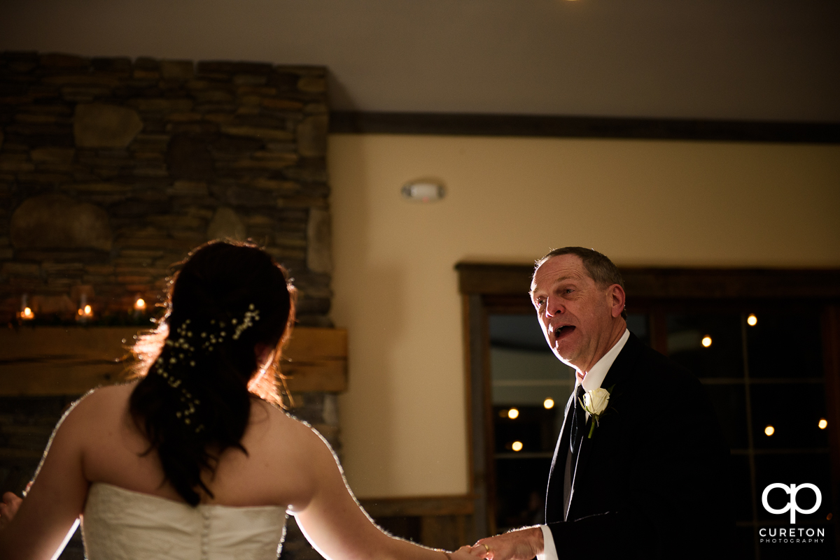 Bride's father dancing with his daughter.