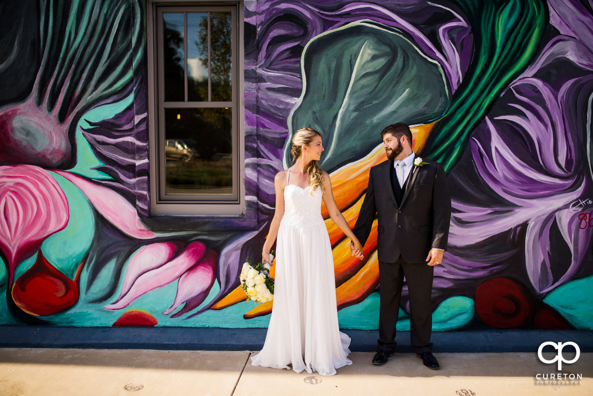 Bride and groom outside their Artisan Traders wedding in downtown Greenville,SC.