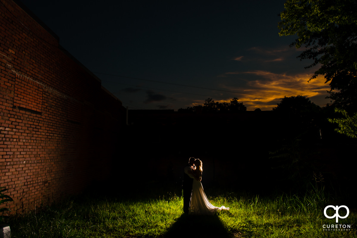 Bride and groom at sunset after their wedding ceremony at Artisan Traders in Greenville.