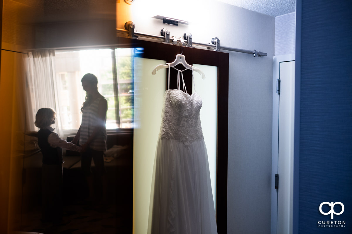 Bride's dress with a reflection of her and her son.