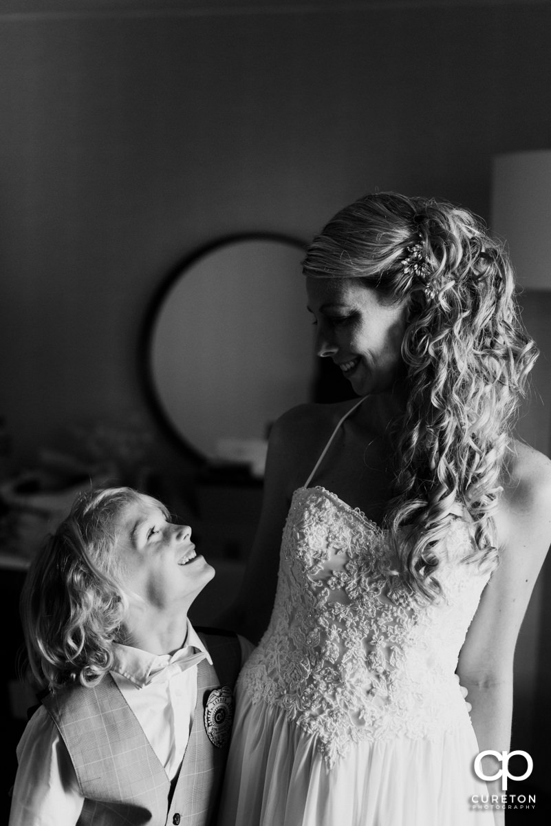 Bride and her son sharing a moment as she gets ready for her wedding.