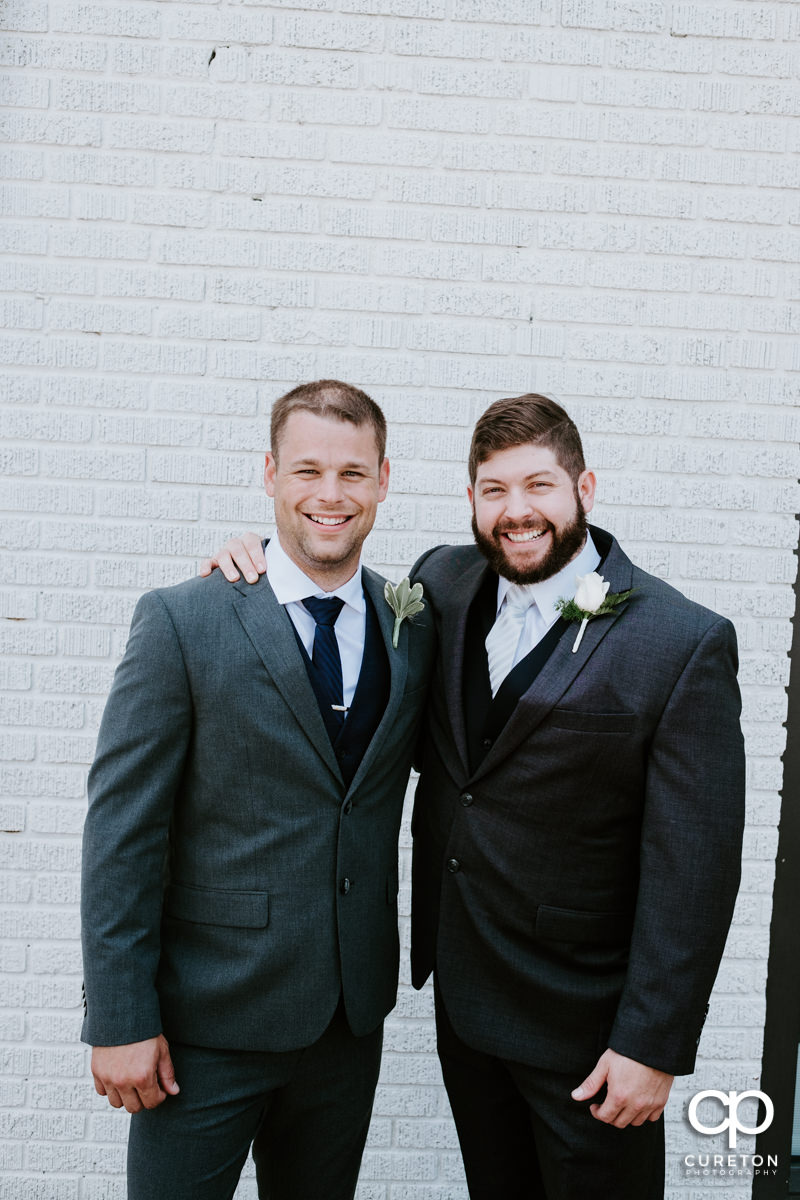 Groom and his best man outside of Artisan Traders.
