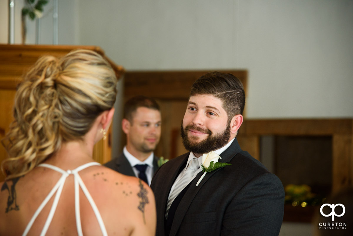 Groom looking at his bride during the wedding ceremony.